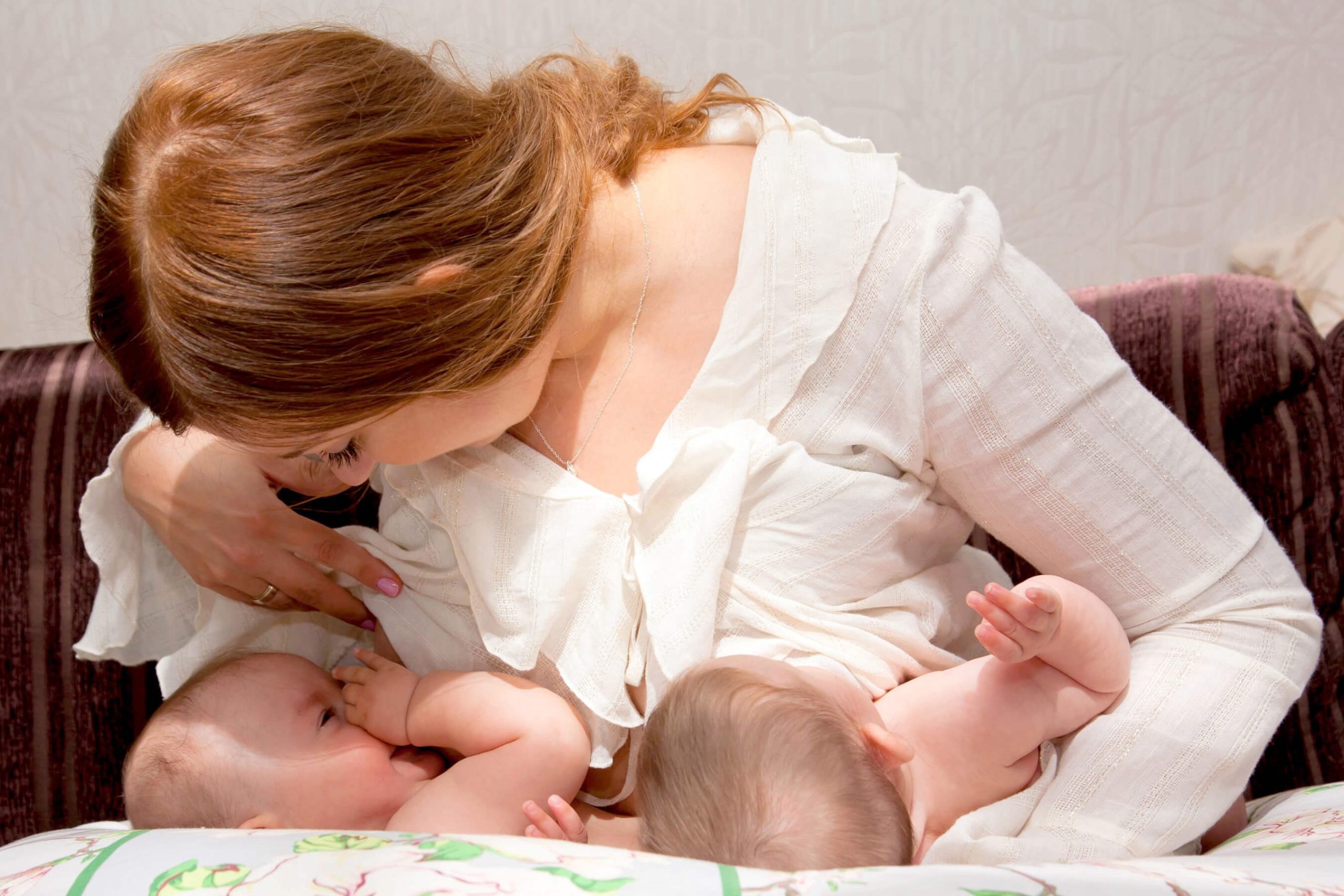 Mother breastfeeding twins