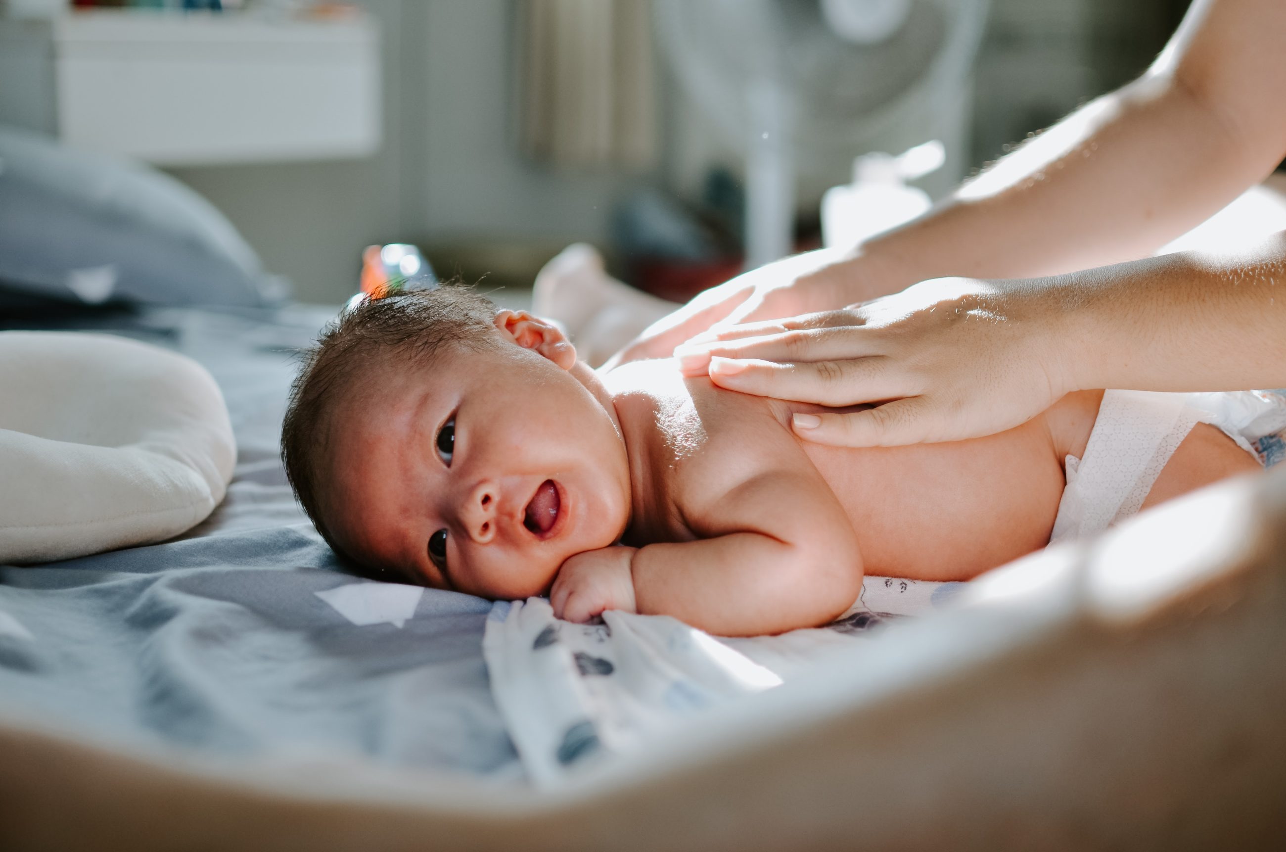 Baby lying on his stomach in the maternity ward